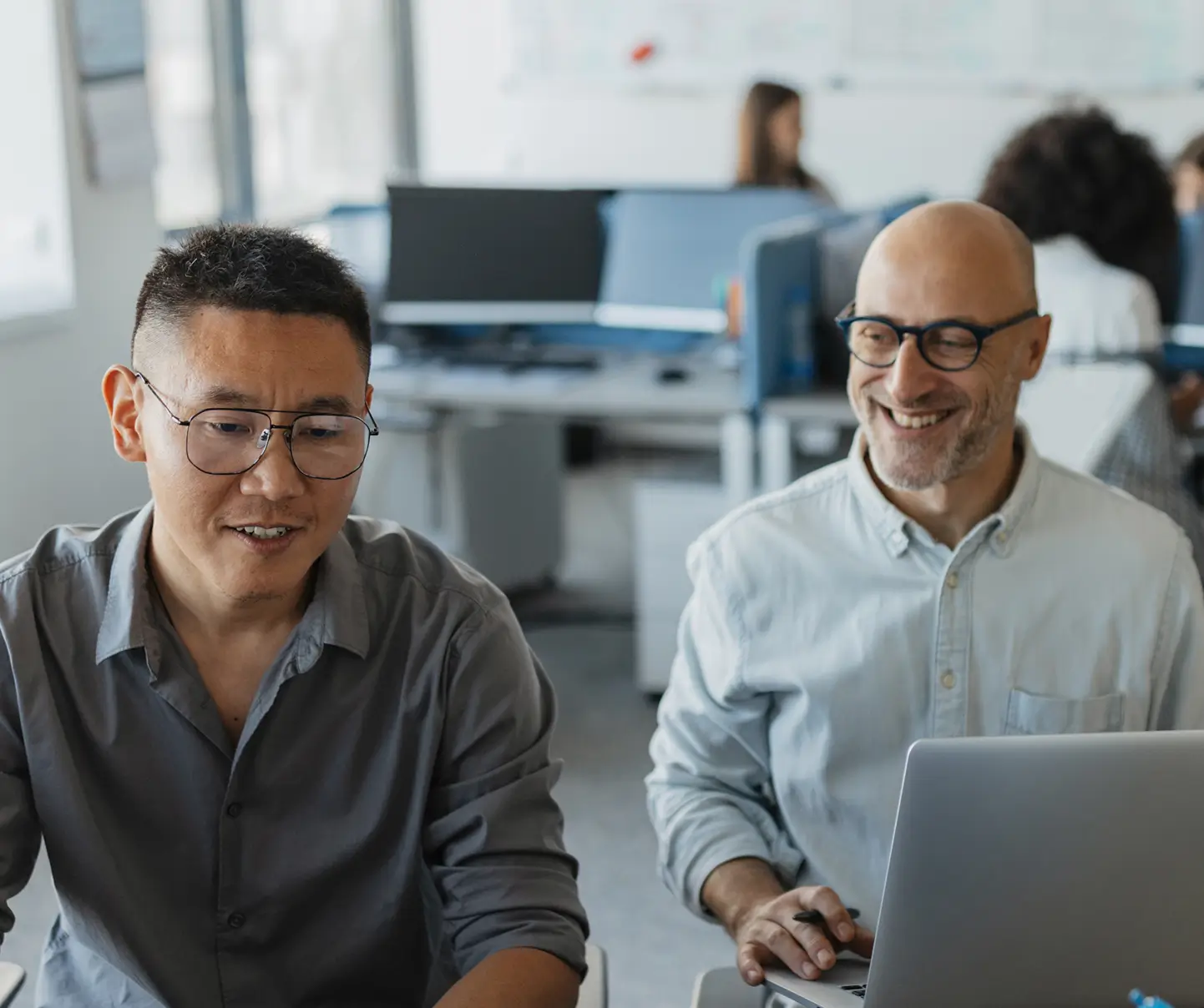 Two employees discussing reports and cyber security strategies.