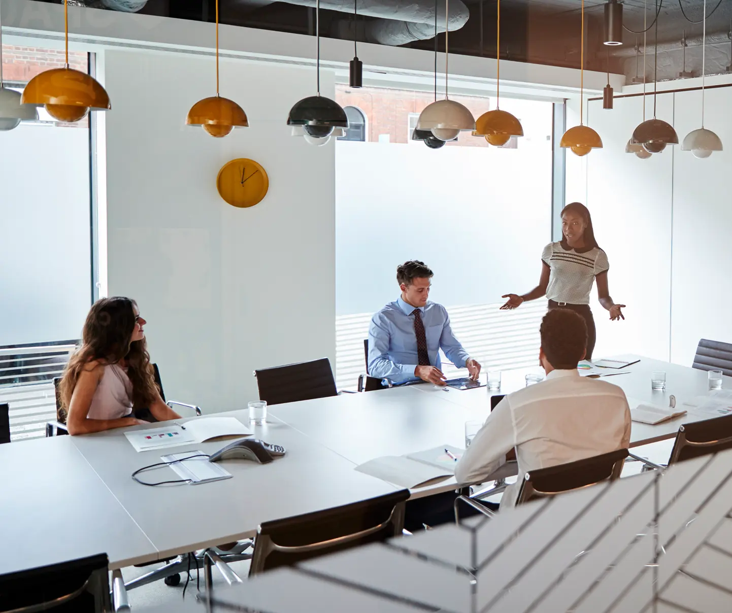 Professionals in a meeting discussing AI innovation and business objectives.