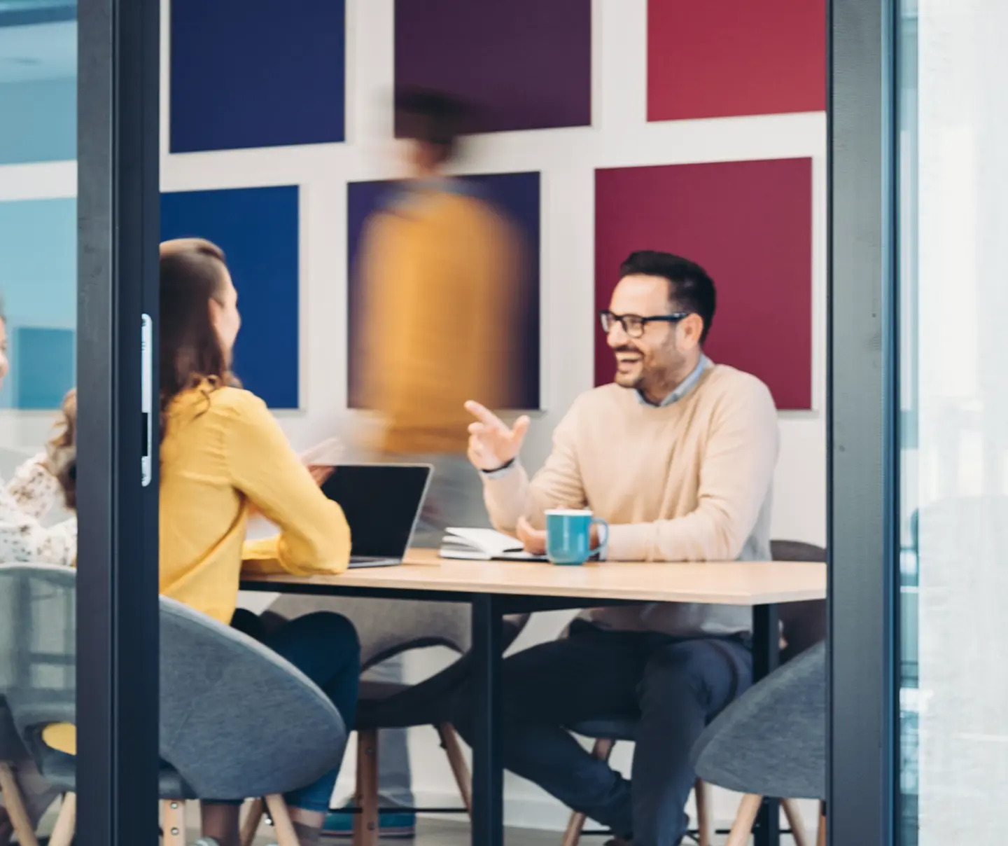 Employees in a meeting discussing PQC roadmap details.