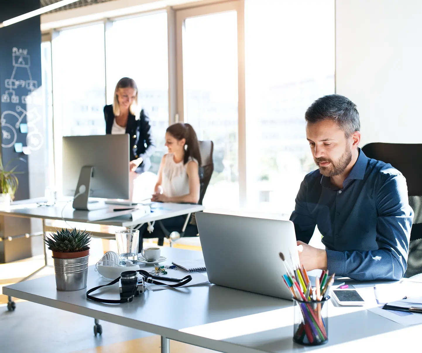 Employees working in an office creating an product roadmap.